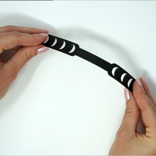 Facemask ear protector being held by two hands on white background