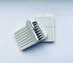 Image of two signia waxtraps with one laying open ontop of the other